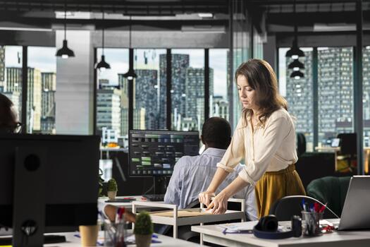 Woman secretary pushing trolley cart with documents and files for coworkers, bringing data reports from the archive to study analytics and performance metrics. Important business intel. photo