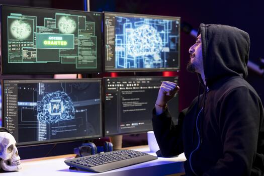 Cheerful man delighted after stealing sensitive information using VPN on dark web. Hacker doing victory hand gesture after seeing access granted message, breaking into systems to take restricted data photo