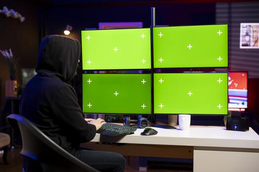 Hacker using chroma key computer to gain unauthorized network access, targeting unpatched connections. Man using multi monitor setup isolated screen PC to bypass security and exploit servers photo