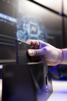 Close up of hacker using SSD to store data gathered from victims using spyware installed on their systems. Evil man inserting hard drive containing exploit used to gain unauthorized access photo