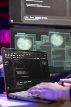 Close up of hacker using malicious malware software on laptop to compromise devices and digital networks, gaining passwords. Man using notebook, stealing, exploiting and illegally selling data online photo