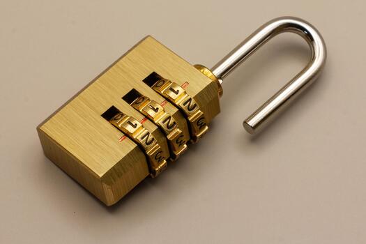 Open golden brass combination padlock, symbolizing unlocked security, successful data access, or a state of vulnerability. Represents privacy, protection, and digital control concepts photo