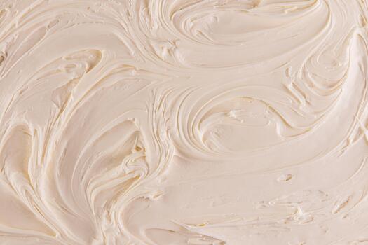 un ejemplo de el elegante textura de crema de mantequilla un hermosa modelo de delicado olas de beige Pastelería crema. parte superior vista. un Copiar espacio. selectivo atención foto