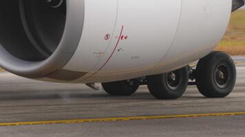 Close-up footage of a modern jet engine in operation, showing the rotating turbine blades and detailed metal textures. The camera captures the power, precision, and advanced engineering video