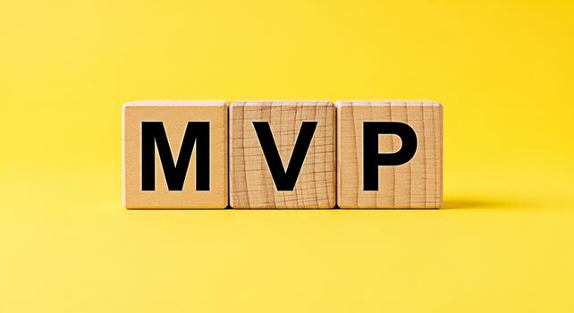 Wooden blocks displaying MVP on a vibrant yellow background symbolizing the concept of a Minimum Viable Product in a startup environment representing efficiency and focus on core features for successf photo
