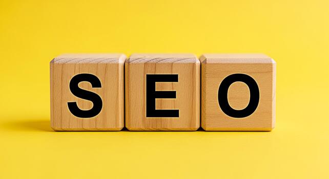 Wooden blocks spelling SEO on a vibrant yellow background representing optimization strategies and digital marketing techniques for improved search engine rankings and online visibility photo