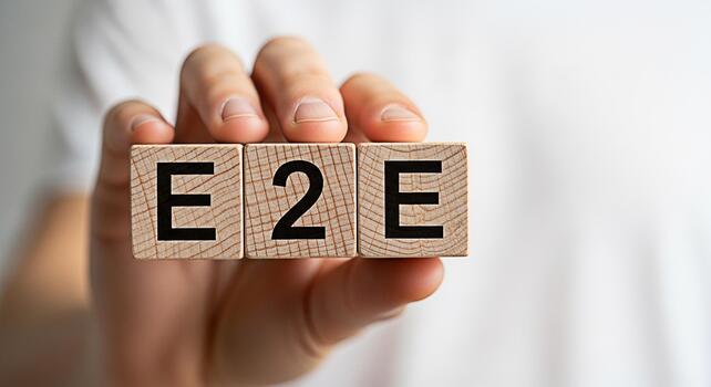 Hand holding wooden blocks spelling E2E in a bright neutral setting symbolizing endtoend process seamless integration and complete solutions for business and technology applications photo