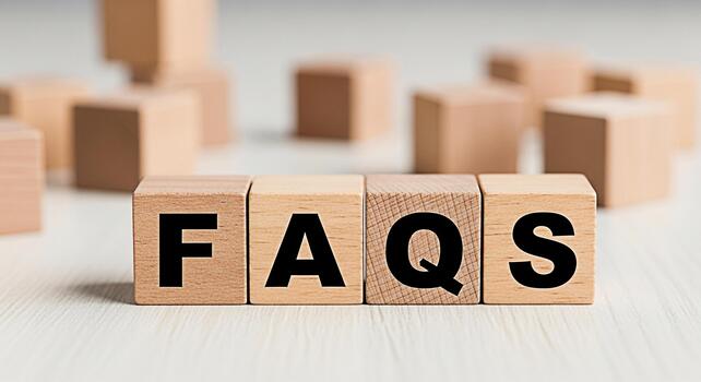 Wooden blocks spelling FAQs on a bright table representing frequently asked questions and information creating a helpful and informative concept with a clean and minimalist aesthetic photo