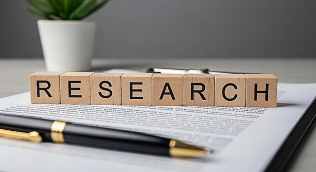 Wooden blocks spelling Research resting on a contract document with a pen in a bright office representing the concept of investigation analysis and the importance of datadriven decisionmaking photo