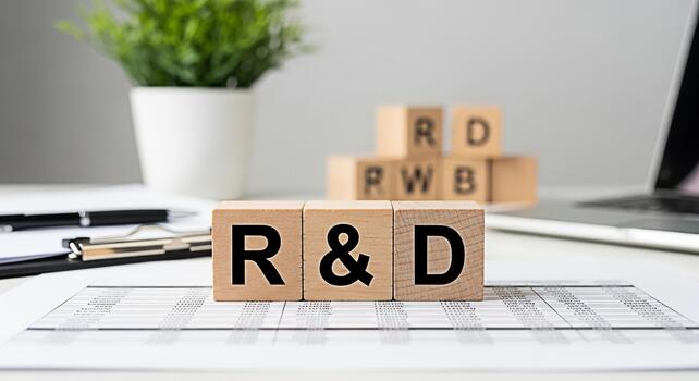 Wooden blocks displaying RD on a bright office desk symbolizing research and development innovation and business strategy in a modern workplace environment fostering a concept of growth and progress photo
