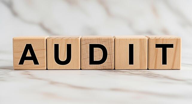 Wooden blocks spelling AUDIT on a marble surface representing financial examination and verification conveying a sense of accountability and transparency in business operations photo