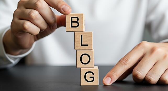 Hands arranging wooden blocks spelling BLOG on a dark table symbolizing content creation and online presence conveying a message of sharing ideas and building a community through blogging photo