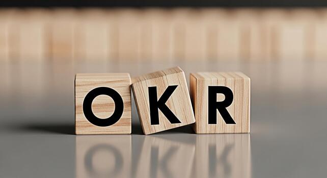 Wooden blocks displaying OKR on a reflective surface symbolizing objectives and key results in a business setting representing strategic planning and goalsetting for organizational success photo