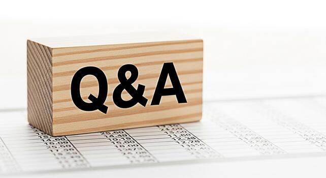 Wooden block displaying QA on a financial document representing questions and answers in a business setting conveying a sense of clarity and information photo