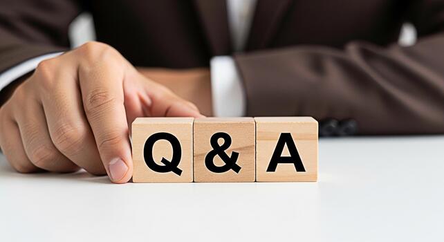 Professional businessman arranging wooden blocks with Q A on a white desk representing questions and answers knowledge sharing and problemsolving in a corporate environment with a focus on clarity photo