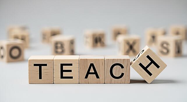 Wooden blocks spelling TEACH on a white surface with other letter blocks scattered in the background symbolizing education learning and the importance of teaching in a bright and clean environment photo