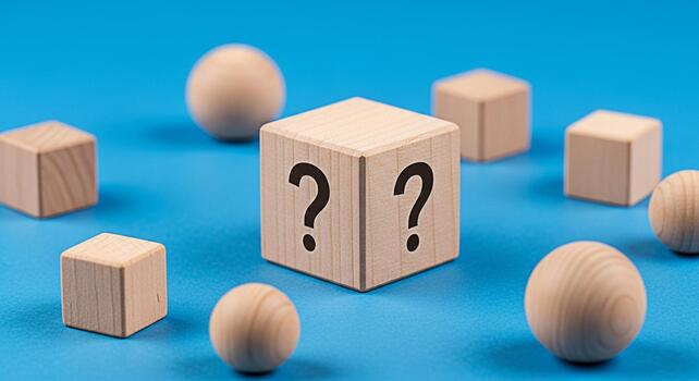 Wooden blocks displaying question marks on a blue surface creating a sense of mystery and uncertainty ideal for illustrating concepts related to problemsolving decisionmaking and unknown challenges photo
