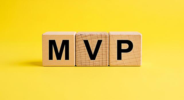 Wooden blocks displaying MVP on a bright yellow background representing the concept of Minimum Viable Product in a startup environment conveying simplicity and focus on core features for business succ photo