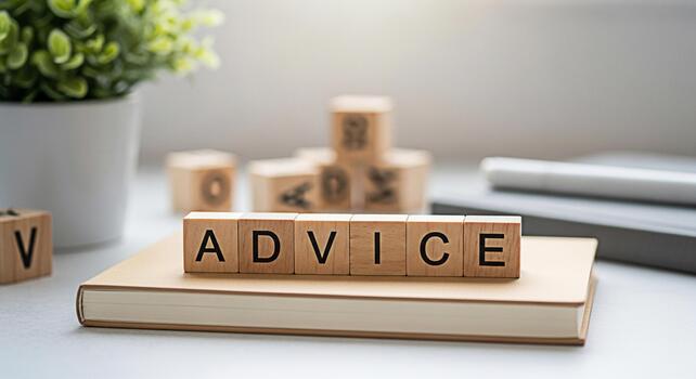 Wooden blocks spelling Advice resting on a notebook in a bright modern office setting symbolizing guidance and support for business decisions and personal growth creating a sense of trust and reliabil photo