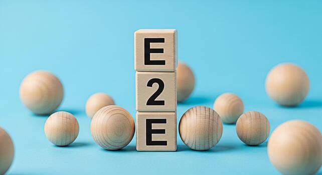 Wooden blocks displaying E2E surrounded by wooden spheres on a blue background symbolizing endtoend solutions and connectivity with a clean minimalist and conceptual representation of business process photo