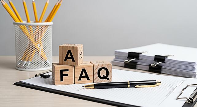 Wooden blocks spelling FAQ resting on a clipboard with a pen in a bright office setting symbolizing information access and customer support with a focus on clarity and helpfulness for user queries photo