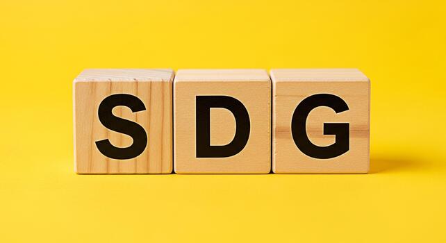 Wooden blocks displaying SDG on a vibrant yellow background symbolizing Sustainable Development Goals and promoting global partnership for a better future representing commitment and progress towards photo