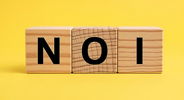 Wooden blocks spelling NOI on a vibrant yellow background representing a clear message with a simple and direct approach conveying a sense of straightforwardness and clarity in communication photo