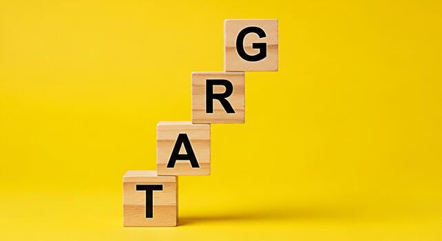 Wooden blocks spelling GREAT stacked on a yellow background symbolizing achievement and success representing a positive message of progress and growth in a vibrant and optimistic setting photo