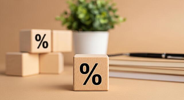 Wooden blocks displaying percentage signs on a desk with a plant and notebook symbolizing financial rates and discounts in a neutraltoned office setting creating a calm and professional atmosphere photo