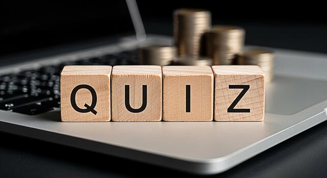 Wooden blocks spelling QUIZ placed on a laptop keyboard with stacks of coins in the background representing online learning financial literacy and the concept of knowledge as currency in the digital a photo