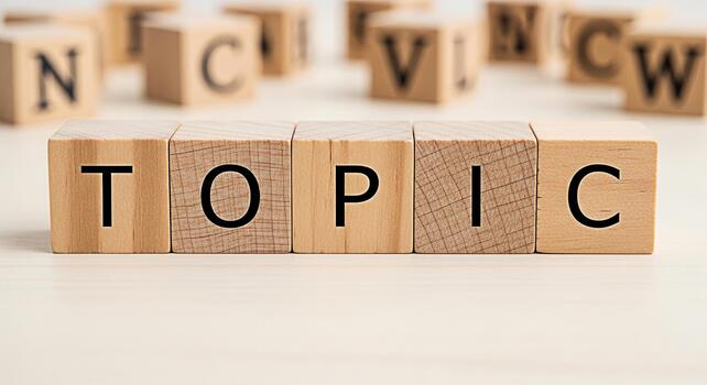 Wooden blocks spelling out TOPIC on a bright surface surrounded by blurred alphabet blocks representing a focused discussion and the importance of clear communication in a learning environment photo