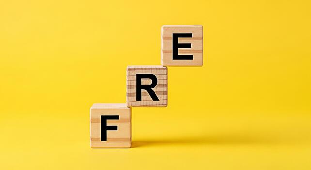 Wooden blocks spelling FREE stacked on a yellow background representing opportunity and accessibility suggesting a sense of openness and availability in a bright and cheerful setting photo