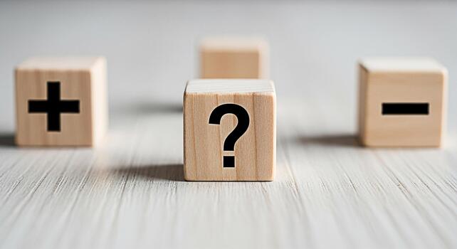 Wooden blocks displaying a question mark plus sign and minus sign on a white wooden surface representing decisionmaking problemsolving and the balance between positive and negative choices in a neutra photo