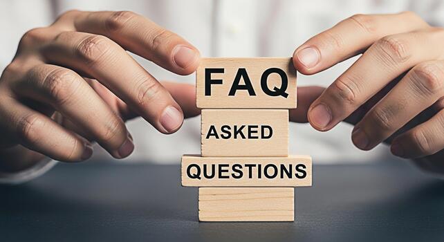 Hands arranging wooden blocks with FAQ Asked Questions on a dark table representing information access and customer support in a professional and informative setting conveying clarity and assistance photo