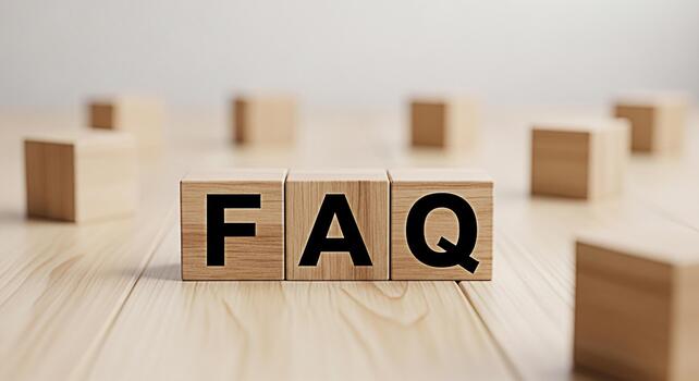 Wooden blocks displaying FAQ on a wooden surface representing frequently asked questions in a simple and clear manner promoting understanding and accessibility in a bright and clean environment photo