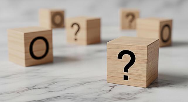 Wooden blocks displaying question marks and the letter O on a marble surface symbolizing uncertainty choices and the search for answers in a clean minimalist environment photo