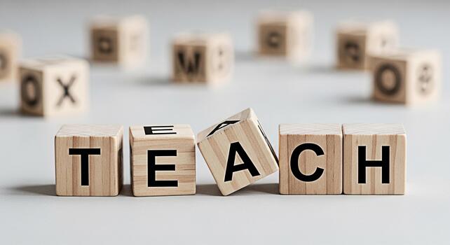 Wooden blocks spelling TEACH on a white surface emphasizing education and learning in a classroom setting creating a positive and inspiring mood for students and educators alike photo