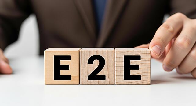 Business professional arranging wooden blocks spelling E2E on a white desk symbolizing endtoend solutions and seamless processes in a corporate environment conveying efficiency and integration photo
