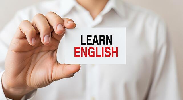 persona en un blanco camisa participación un tarjeta con el texto aprender Inglés en un brillante estudio ajuste promoviendo idioma educación y global comunicación con un atención en accesibilidad y superación personal foto