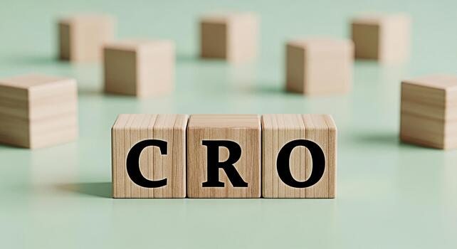 Wooden blocks displaying CRO on a light green surface representing Conversion Rate Optimization in a minimalist setting conveying a message of business growth and digital marketing strategy photo