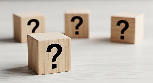 Wooden blocks displaying question marks on a bright surface representing uncertainty and the search for answers in a minimalist and conceptual setting evoking curiosity and problemsolving photo