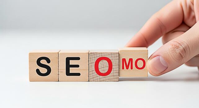 Hand arranging wooden blocks spelling SEO MO on a white surface representing search engine optimization and marketing strategies for online business growth and success in a competitive digital environ photo