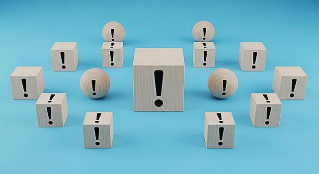 Wooden blocks and spheres displaying exclamation points on a blue surface symbolizing urgency warning and the importance of attention to detail in a clean and minimalist environment photo