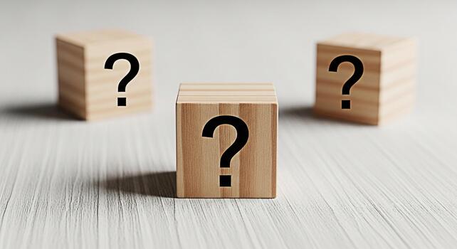Three wooden blocks displaying question marks on a white wooden surface symbolizing uncertainty and the need for solutions in a bright minimalist setting creating a sense of curiosity and anticipation photo
