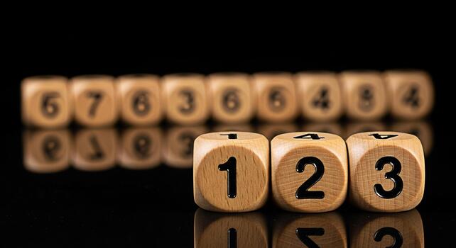 Wooden dice displaying numbers in a dark studio setting representing sequence order and the concept of counting with a focus on numerical progression and the importance of mathematics photo