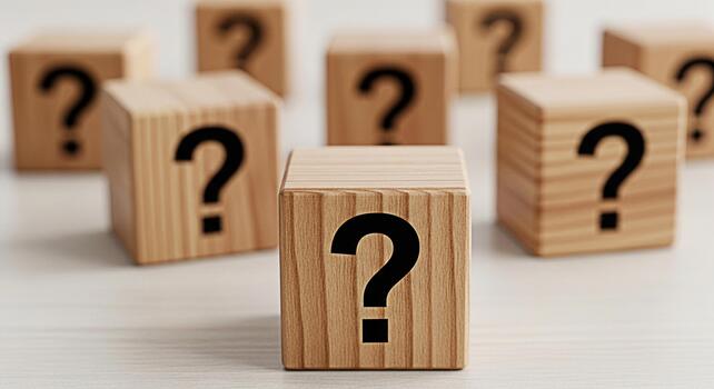Wooden blocks displaying question marks on a white surface representing uncertainty and the search for answers in a clean and minimalist setting evoking curiosity and the exploration of unknown possib photo