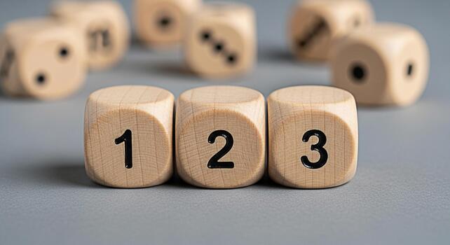 Wooden dice displaying numbers one two and three on a gray surface representing sequential steps order and a playful approach to learning and decisionmaking in a minimalist setting photo