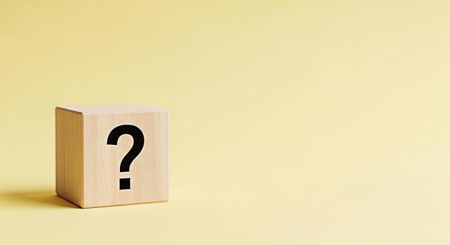 Wooden block displaying a question mark on a yellow background representing uncertainty and the need for answers creating a sense of curiosity and problemsolving photo