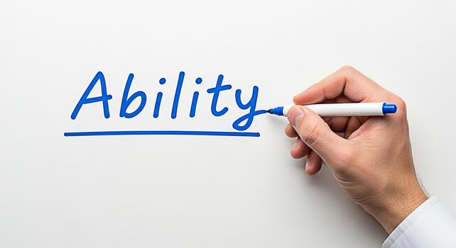 A hand writing the word Ability on a white surface with a blue marker emphasizing the concept of skill and potential in a clean and professional setting symbolizing competence and capability photo