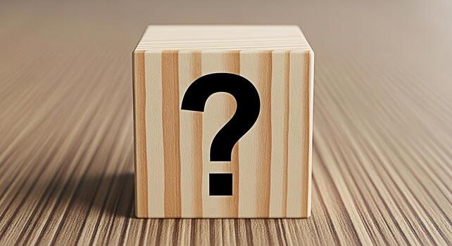 Wooden block displaying a question mark on a textured surface symbolizing uncertainty and the search for answers in a simple minimalist setting evoking curiosity and problemsolving photo